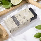 Savon naturel bergamote santal ambiance fraîche et boisée sortant du packaging dans ambiance naturelle