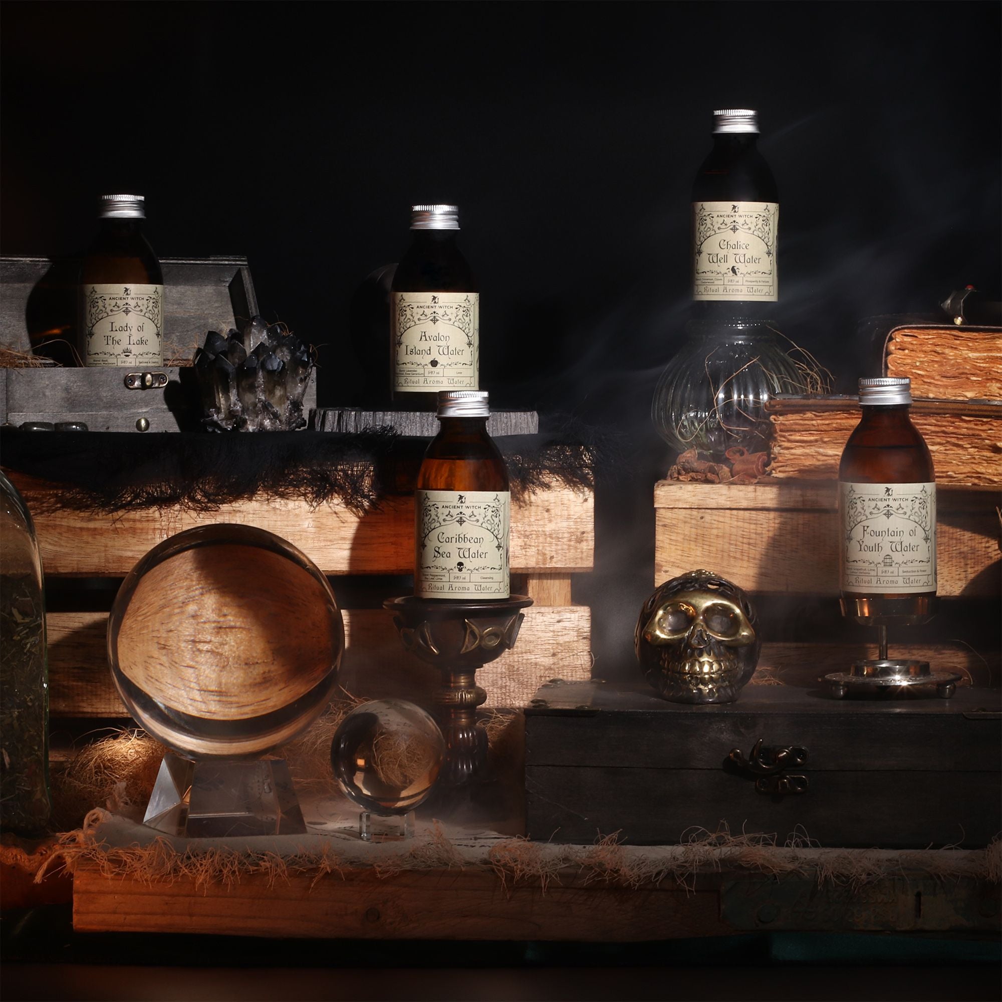 Plusieurs flacons d’eaux rituelles Ancient Witch disposés dans un décor ésotérique avec objets spirituels et ambiance mystique