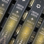 Boîtes encens smudge cristal oeil de tigre vanille empilées avec design noir et motifs lune et étoiles