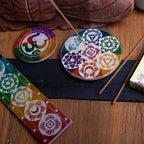 Porte-encens Om 8 cm en pierre posé avec modèles chakras, accessoires spirituels pour autel et purification énergétique.